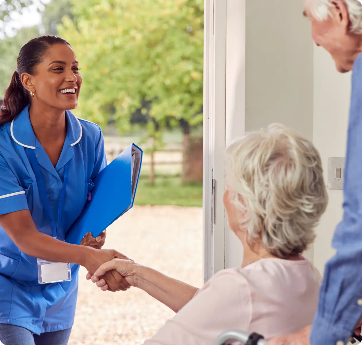 An smiling nurse enters a house